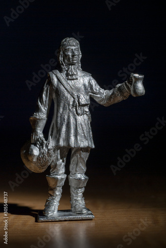 Musketeer made in white metal holding a tankard and hat male figure standing
