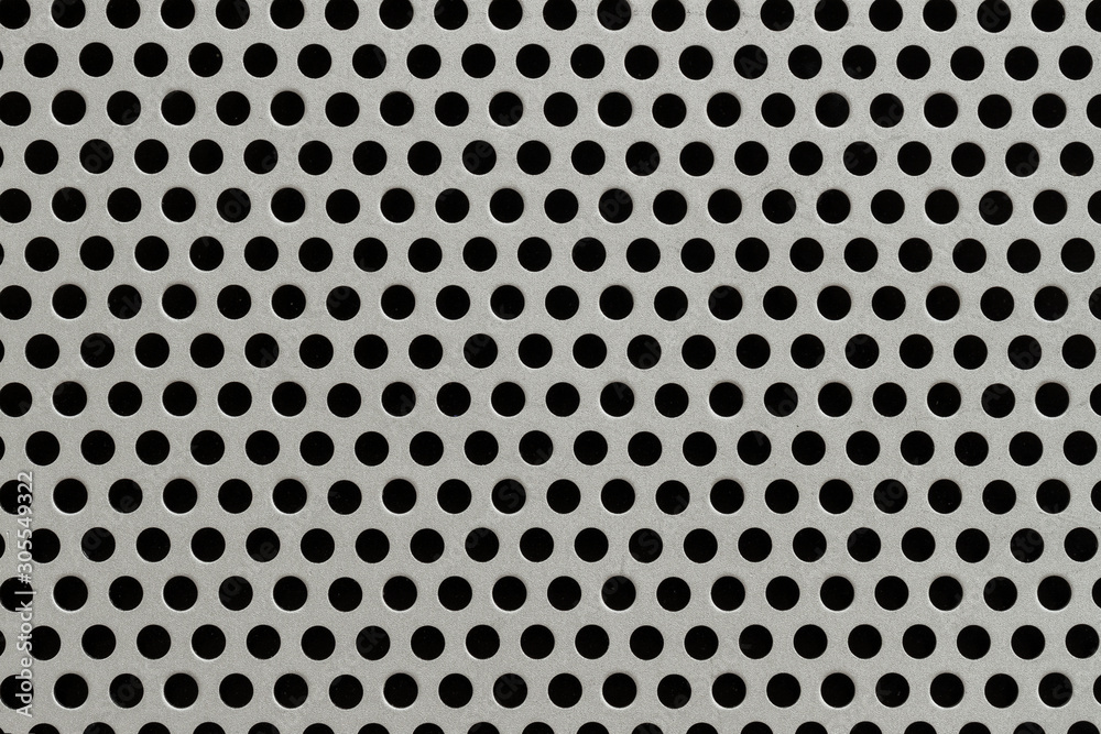 Metal grid texture with holes close-up, silver steel surface, modern background Metal grid texture with holes close-up, silver steel surface, modern background