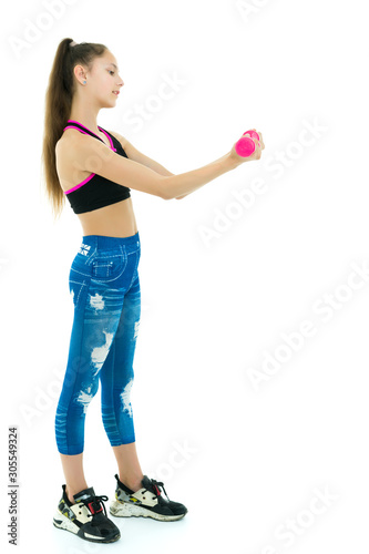 Teenage girl with dumbbells in hands