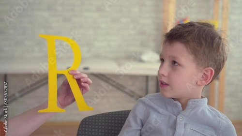 Preschooler engaged in the study of the alphabet with the teacher