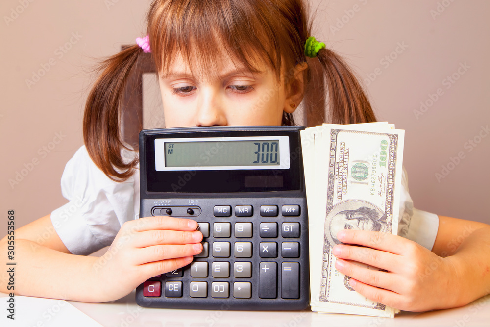 Humorous photo of young serious business girl holding US Dollar bills and calculator Humorous photo of young serious business girl holding US Dollar bills and calculator