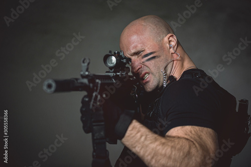 Concept photo of aiming special agent man with a rifle. Person with airsoft gun. Thriller film concept.