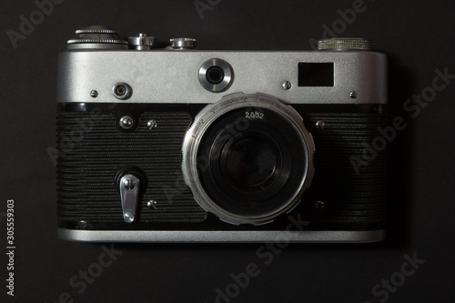 Retro film photo camera on black background