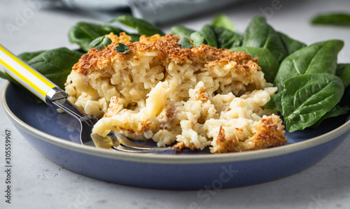 Mac and cheese, American style macaroni pasta with cheesy bechamel sauce and crunchy breadcrumbs topping. Pasta and cheese casserole.