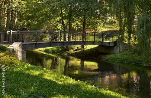 Footbridge over Lyna river and alley Chateauroux at Park Podzamcze in Olsztyn. Poland   photo