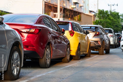 Red and yellow cars parking in line.