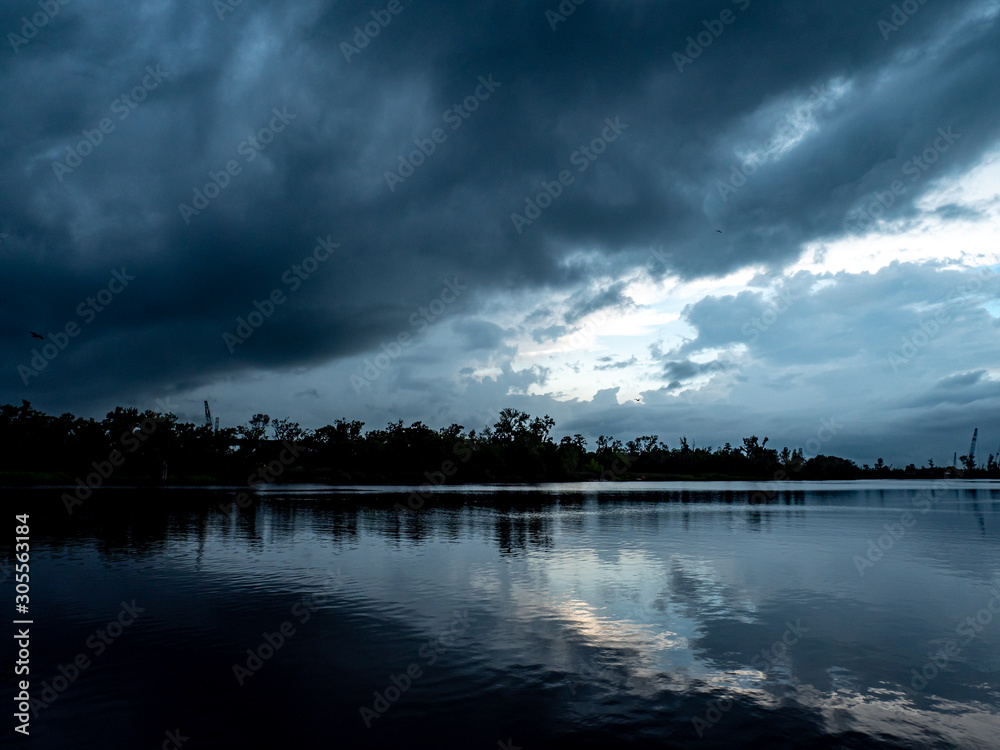 Sky reflecting off the lake or river on a stormy evening Sky reflecting off the lake or river on a stormy evening