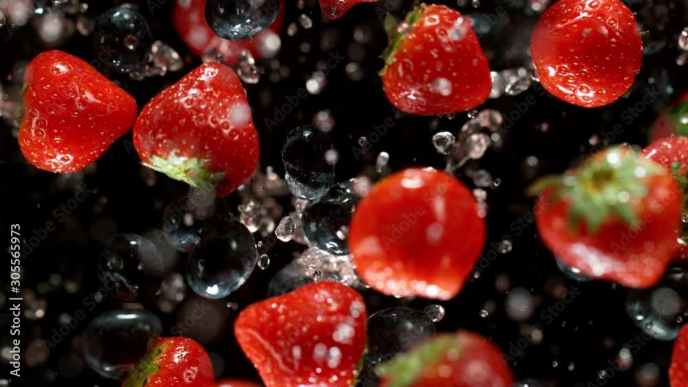 Exploding strawberries on a black background. Filmed on high speed cinema camera, 1000fps.