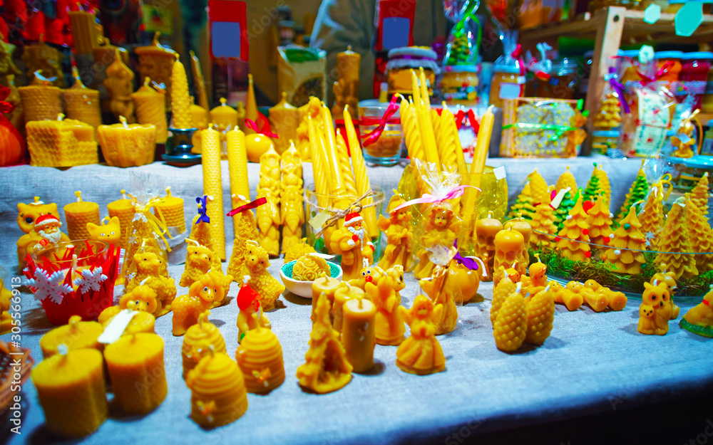 Fototapeta premium Wax candles at Christmas Market in Winter Vilnius, Lithuania. Advent Fair Decoration and Stalls with Crafts Items on the Bazaar. Lithuanian street Xmas and holiday in European city