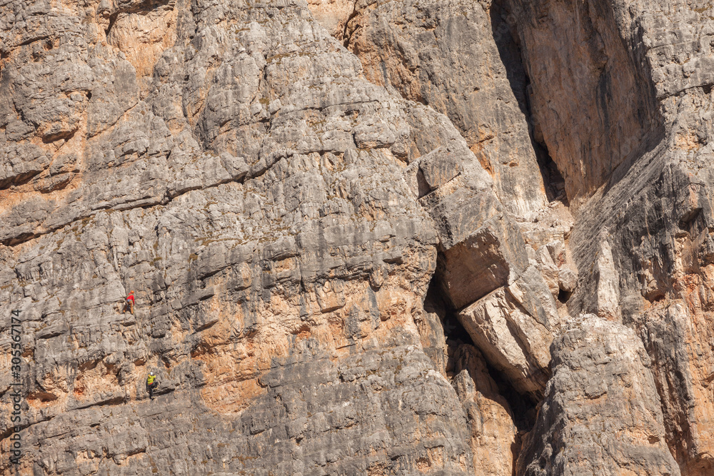 Rock climbers in action over a vertical cliff in the Cinque Torri area in Dolomites Rock climbers in action over a vertical cliff in the Cinque Torri area in Dolomites
