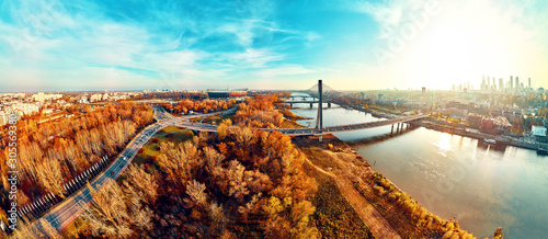 Beautiful panoramic aerial dsrone view to Swietokrzyski Bridge (Polish: Świętokrzyski) and The PGE Narodowy or National Stadium - football stadium located in Warsaw, Poland in autumn evening at sunset