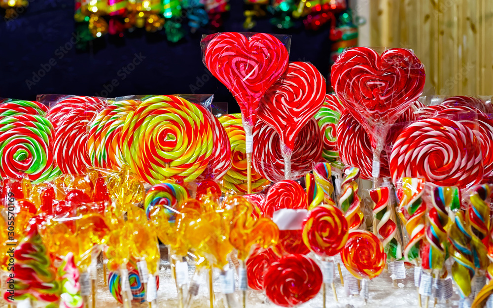 Lollipop candies in Christmas market in Lithuania Europe in winter. Sweet food at Lithuanian Night street Xmas and holiday fair European city or town, December. Vilnius