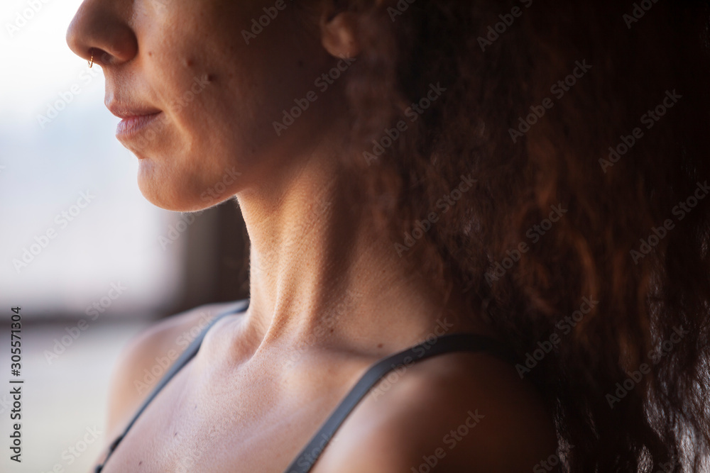 Extreme close up of a Womans neck and mouth as she looks out window Extreme close up of a Womans neck and mouth as she looks out window