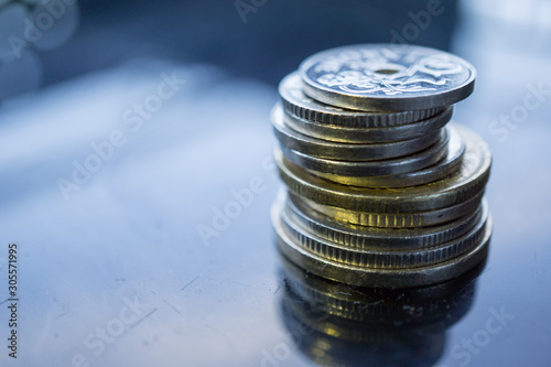 Photography Close-up of stack of coins on dark background