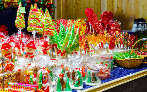 Lollipop candies in Christmas market in Lithuania Europe in winter. Sweet food at Lithuanian Night street Xmas and holiday fair European city or town, December. Vilnius