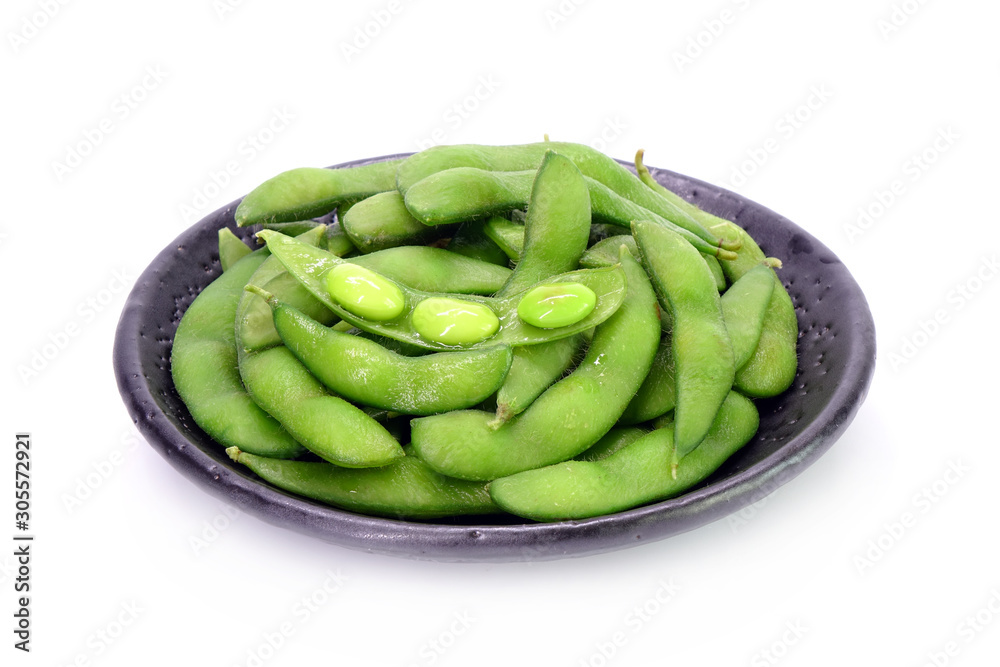 Edamame beans on Japanese black earthenware dish Isolated on white background. Steamed salted soybeans, the popular appetizer of Japanese cuisine. Edamame beans on Japanese black earthenware dish Isolated on white background. Steamed salted soybeans, the popular appetizer of Japanese cuisine.