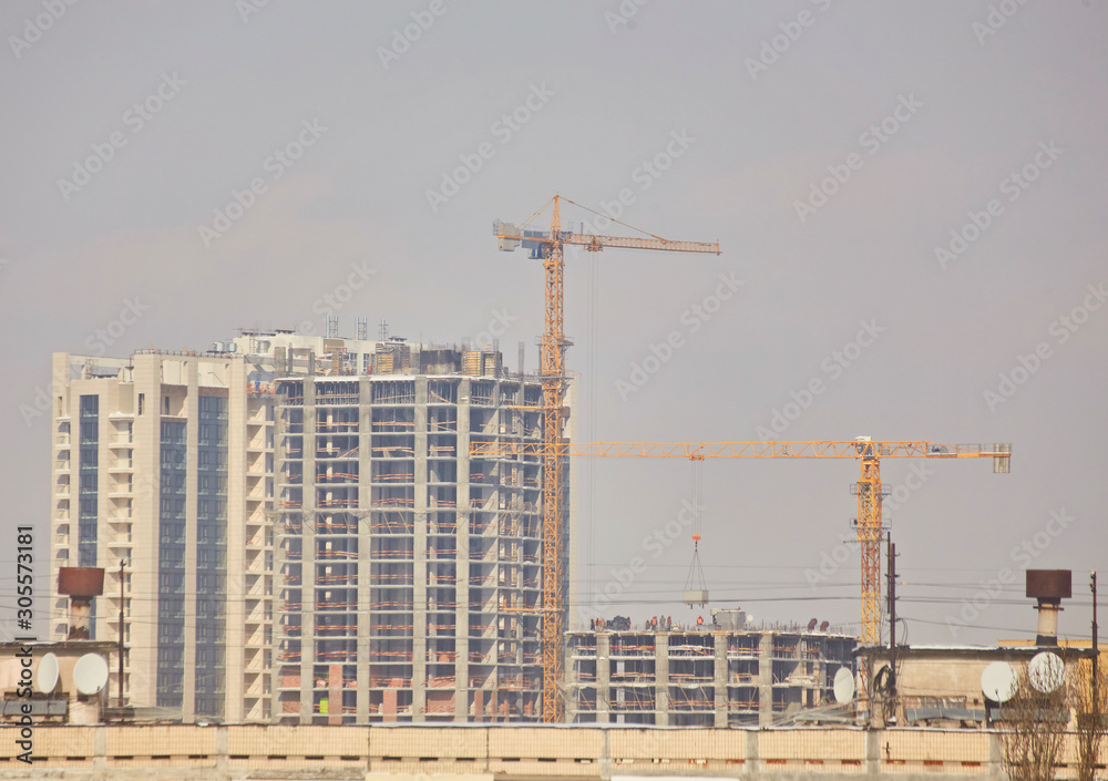 unfinished building construction and building cranes unfinished building construction and building cranes