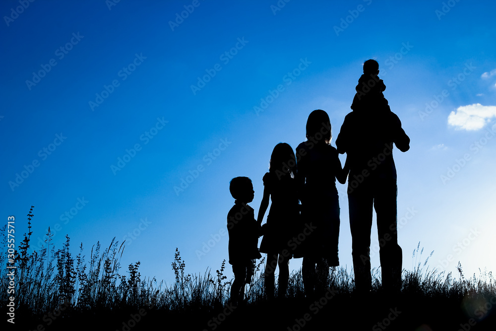 happy family outdoors in the park silhouette