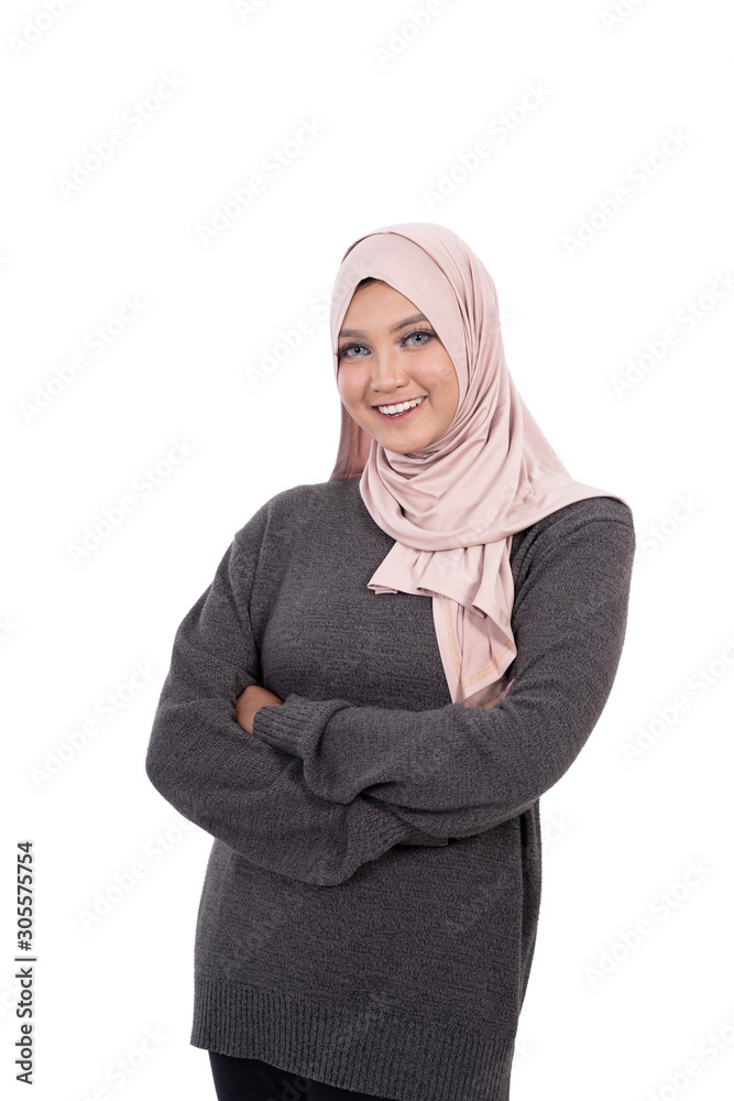 Pose of hijab woman with crossed hands and smile look at camera at isolated background Pose of hijab woman with crossed hands and smile look at camera at isolated background