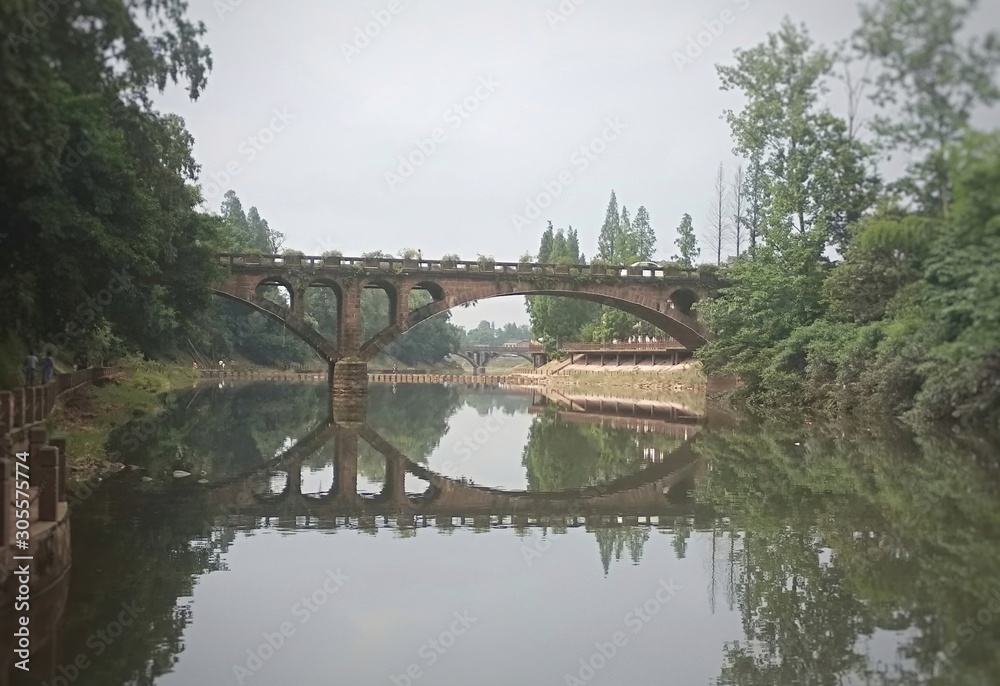 beautiful landscape of a bridge over a river in china with reflection in the water