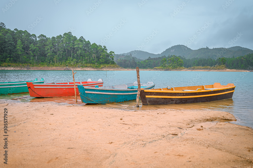 Colored boats by the lake on a cloudy day