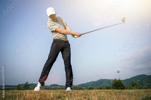 Blurred images of golfers who hit golf balls with scattered grass. photo