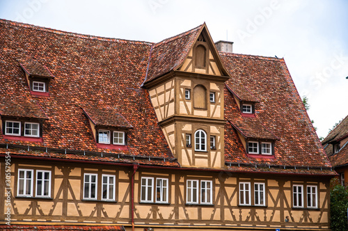 German wood framed house with red tiled roof and chimney