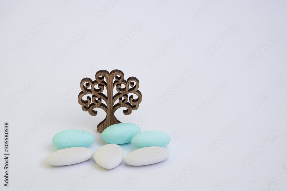 Fotografie Confetti in the foreground with stylized tree on a light background