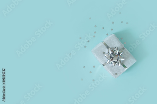 Christmas banner. Xmas silver and glitter gift box, blue background. Horizontal poster, greeting card, headers, website. Decoration objects flat lay, top view