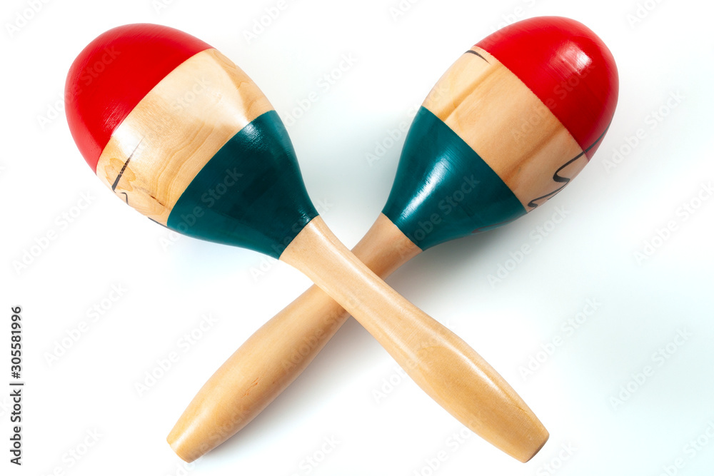 Caribbean and latin music and traditional musical instruments conceptual idea with wood maracas or rumba shakers isolated on white background with clipping path cutout