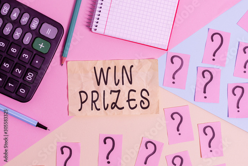 Writing note showing Win Prizes. Business concept for something given for victory in a contest or competition Mathematics stuff and writing equipment above pastel colours background