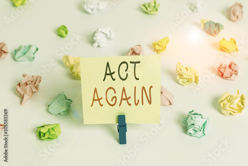 Word writing text Act Again. Business photo showcasing do something for a particular purpose Take action on something Colored crumpled papers empty reminder white floor background clothespin © Artur