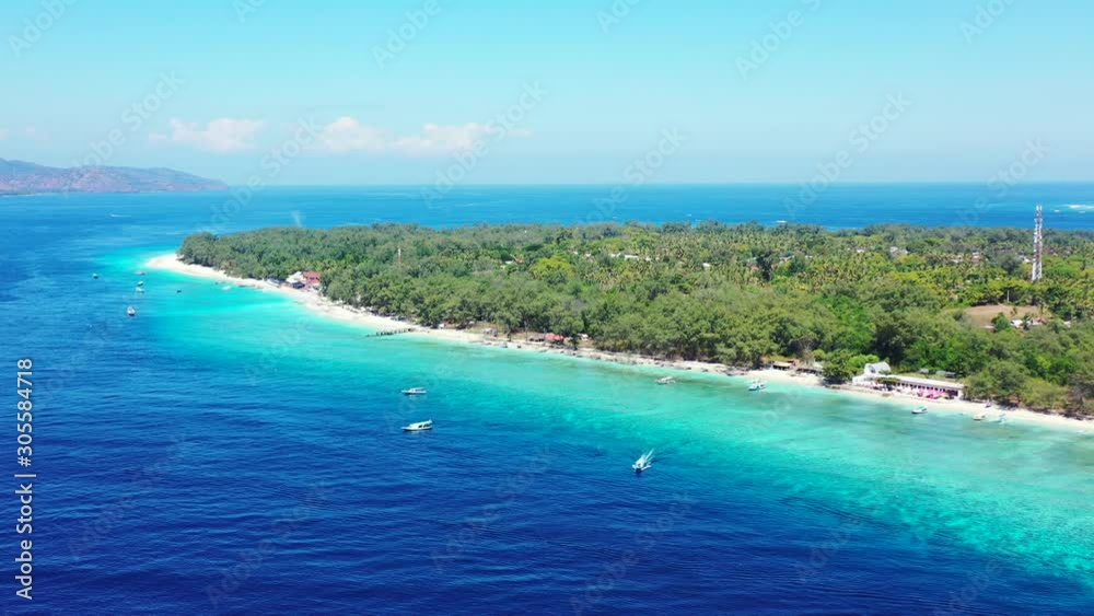 Island In Caribbean - Lush Island Surrounded By Bright Blue Ocean Water Under The Blue Sky On A Sunny Day - Aerial Drone Shot