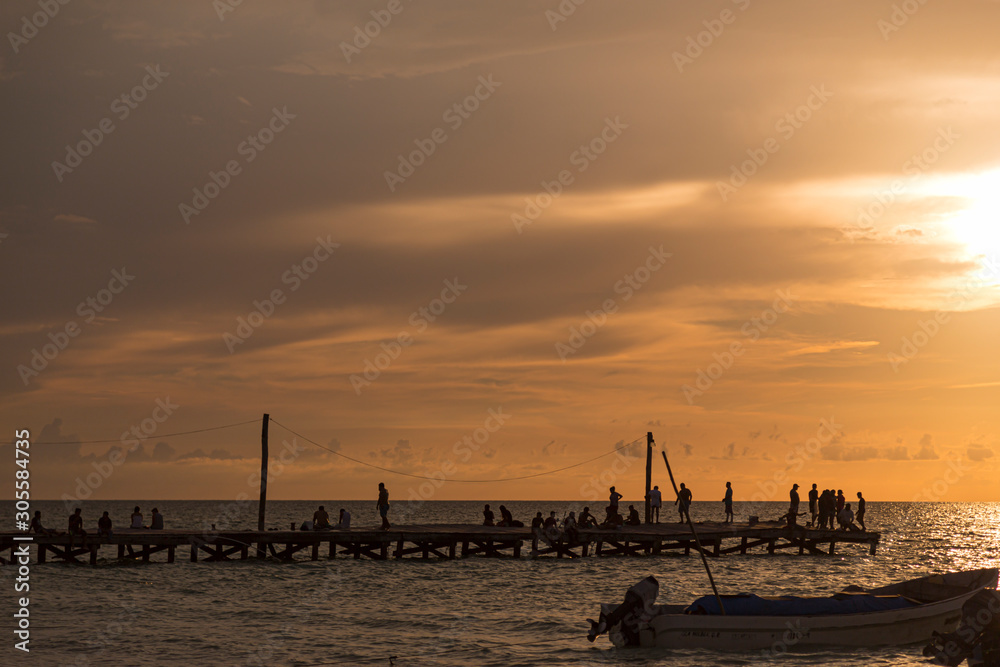 Fishermen in the mexican caribbean sea sunset