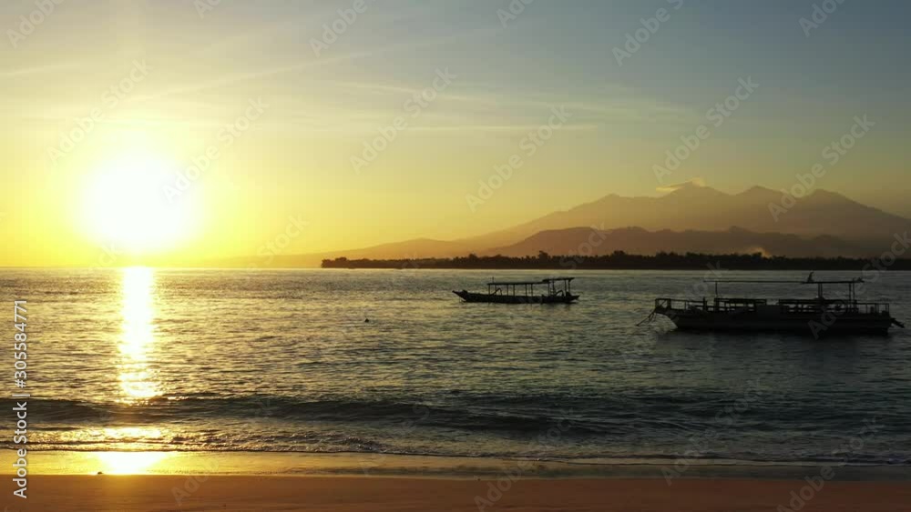 Samoa Island - Scenic Sunrise of the island over the boats floating on the pristine ocean of the Pacific and mountain stretch on the background - Wide Shot Samoa Island - Scenic Sunrise of the island over the boats floating on the pristine ocean of the Pacific and mountain stretch on the background - Wide Shot