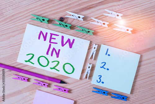 Text sign showing New In 2020. Business photo showcasing list of fresh things got introduced this year or the next Colored clothespin papers empty reminder wooden floor background office