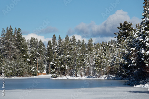 Snow Lined Frozen Small Mountain Lake photo