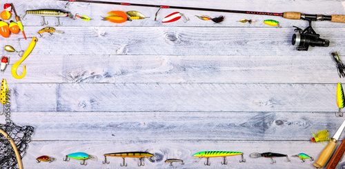Fishing tackle overhead on wooden background with copy space