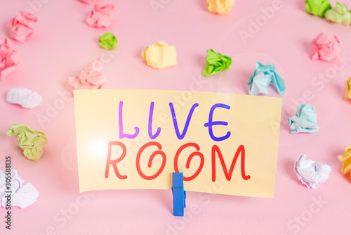 Word writing text Live Room. Business photo showcasing the room in a house or apartment that is used for relaxing in Colored crumpled papers empty reminder pink floor background clothespin
