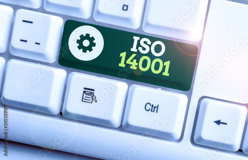 Writing note showing Iso 14001. Business concept for a family of standards related to environmental analysisagement White pc keyboard with note paper above the white background