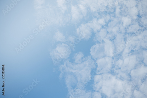 The clear blue sky with clouds alternating large and small lumps.