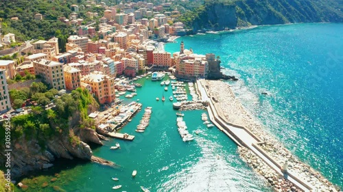 Aerial view of Camogli harbor. Colorful buildings near the ligurian sea beach, Italy. View from above on boats and yachts moored in marina with green blue water. photo