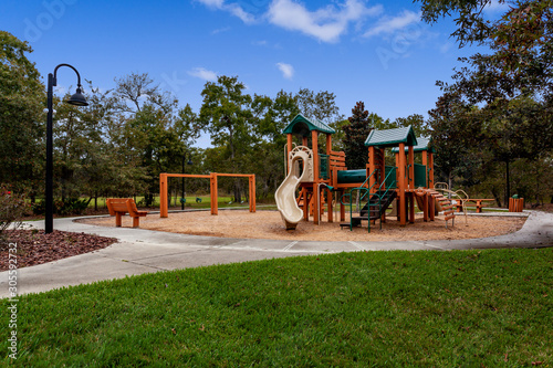 Wooden playground with a slide and swingset photo