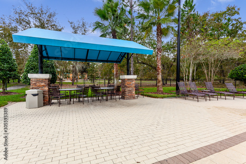 Picnic tables under a blue covering