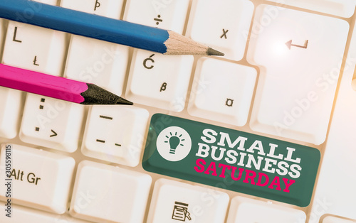 Text sign showing Small Business Saturday. Business photo showcasing American shopping holiday held during the Saturday White pc keyboard with empty note paper above white background key copy space