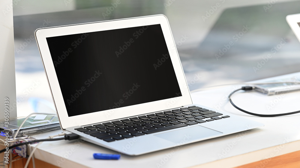 Small laptop computer on fixed table. Small laptop computer on fixed table.