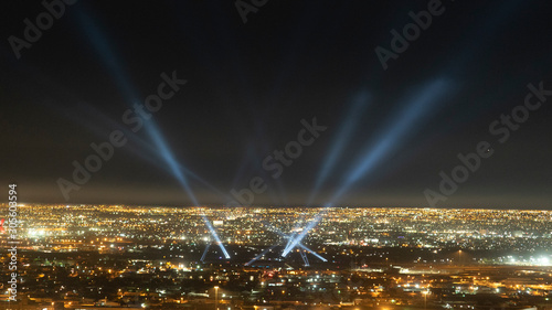 Beams of Light from City Spotlights at Night