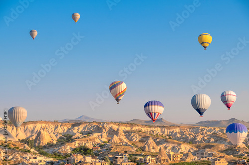 Balloon hot air over Göreme against blue sky, Cappadocia, Turkey