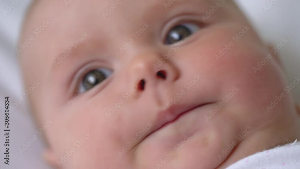 Close-up of newborn baby face, infant learning world around, beginning of life Close-up of newborn baby face, infant learning world around, beginning of life