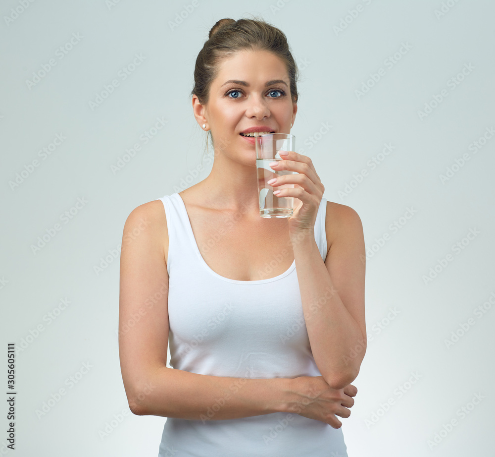 smiling sporty woman in white casual vest holding water glass. smiling sporty woman in white casual vest holding water glass.